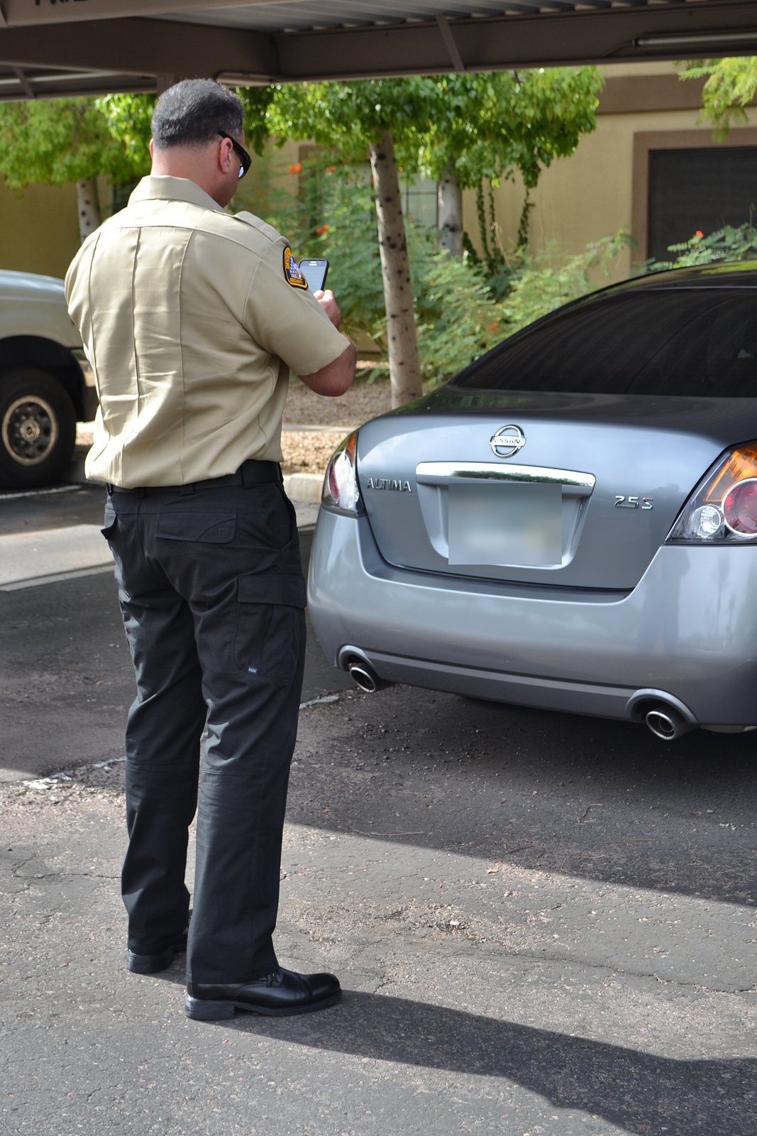 SecureOne security officer checking a parked vehicle
